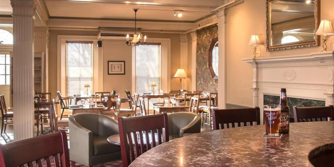 A restaurant and bar with comfortable chairs and large windows. with a lot of natural light. 