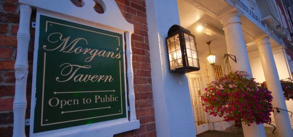 Exterior of the inn shoes the morgan's tavern sign on the brick.