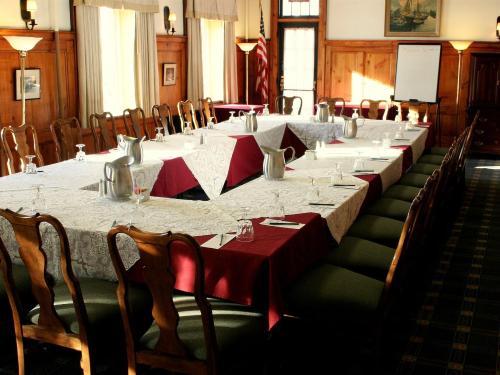 A meeting is set up with a large table and chairs around it.